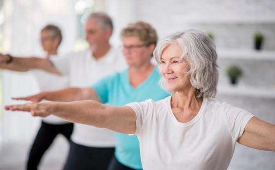 Group of older people doing yoga