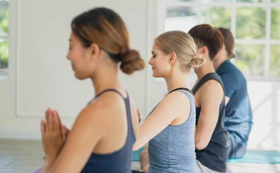 people sat on the floor doing yoga