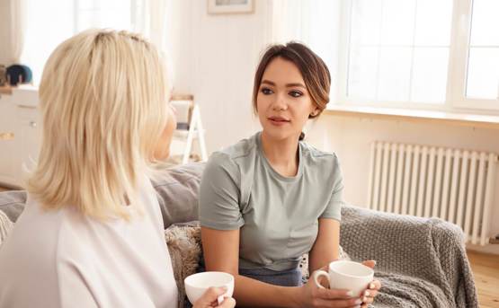 Two women drinking tea and talking 